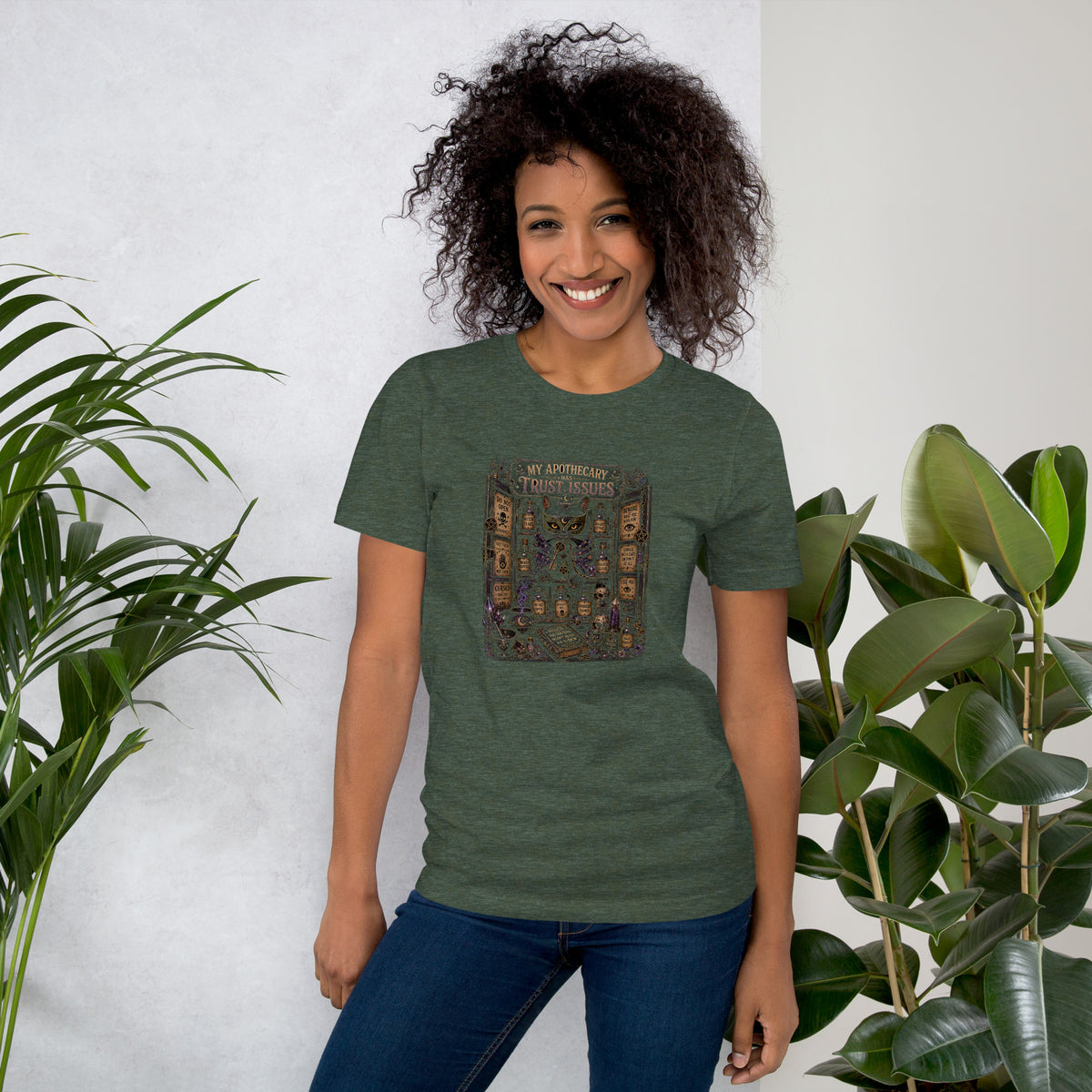 My Apothecary Has Trust Issues, a witchy black cat and a cabinet of potion bottles, on a heather forest unisex t-shirt, front view