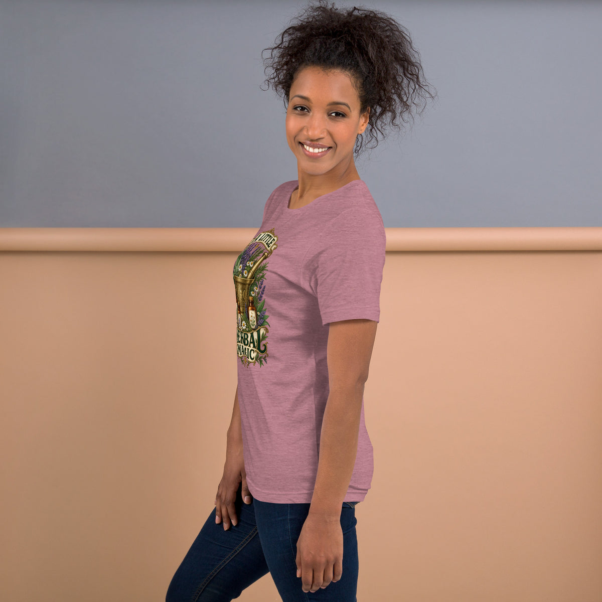 A Little Herbal Magic design, a gold mortar and pestle filled with lavender and chamomile, on a heather orchid unisex t-shirt, left side view