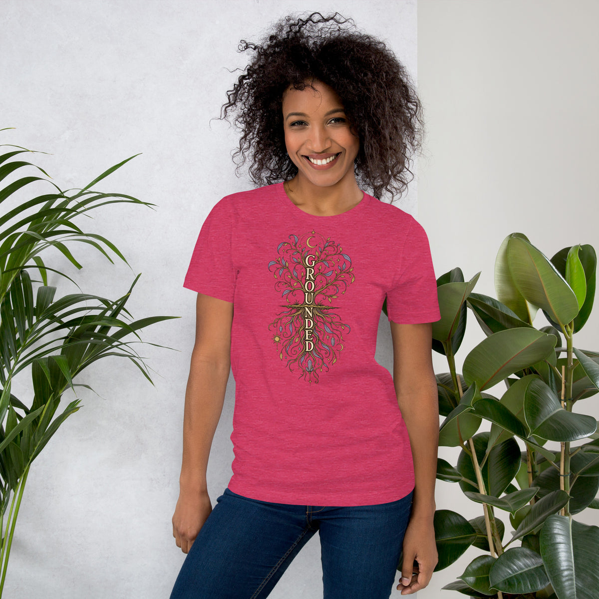 Own Your Grounded Energy design, an ornate tree with gold leaves and crystals in its roots, on a heather raspberry unisex t-shirt, front view