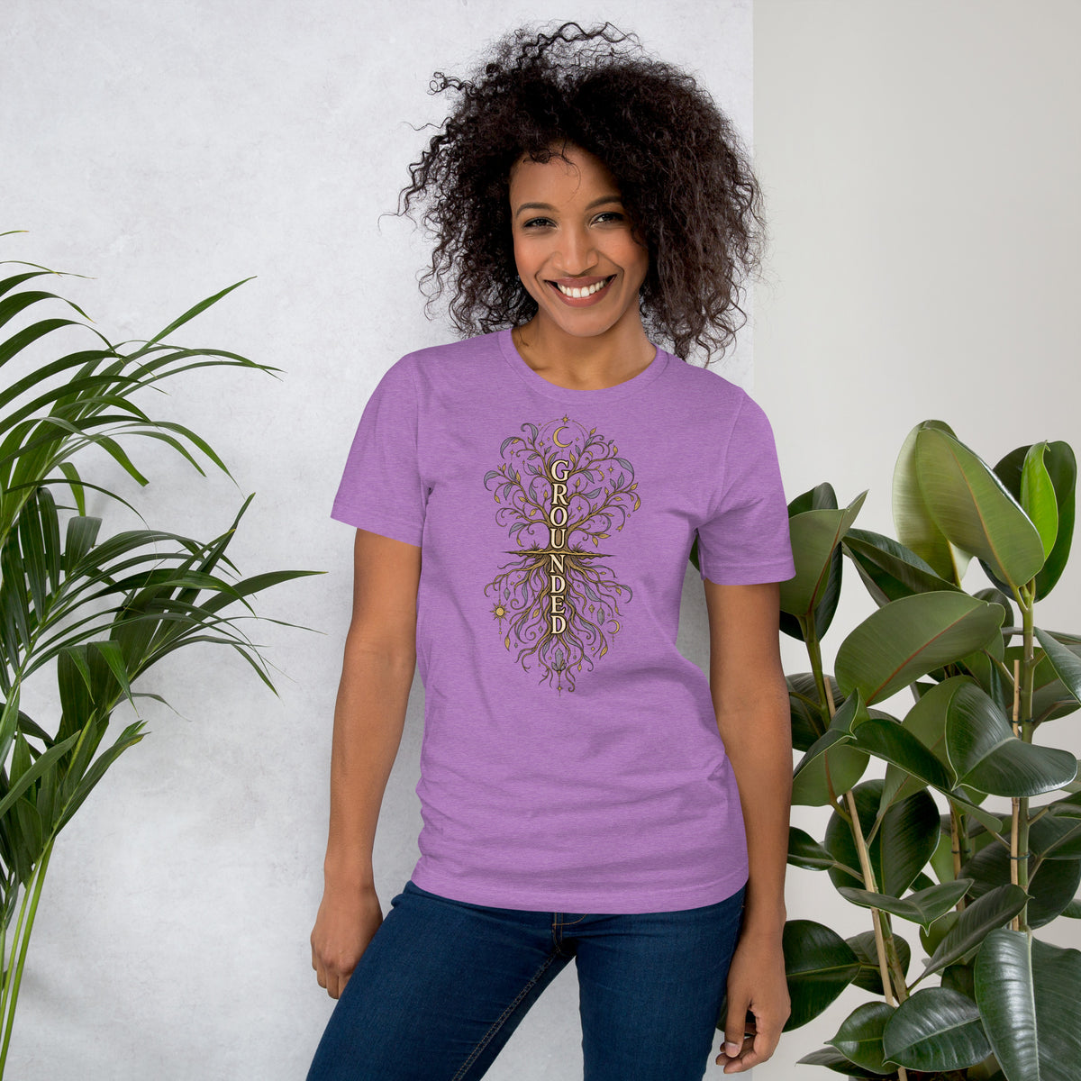 Own Your Grounded Energy design, an ornate tree with gold leaves and crystals in its roots, on a heather team purple unisex t-shirt, front view