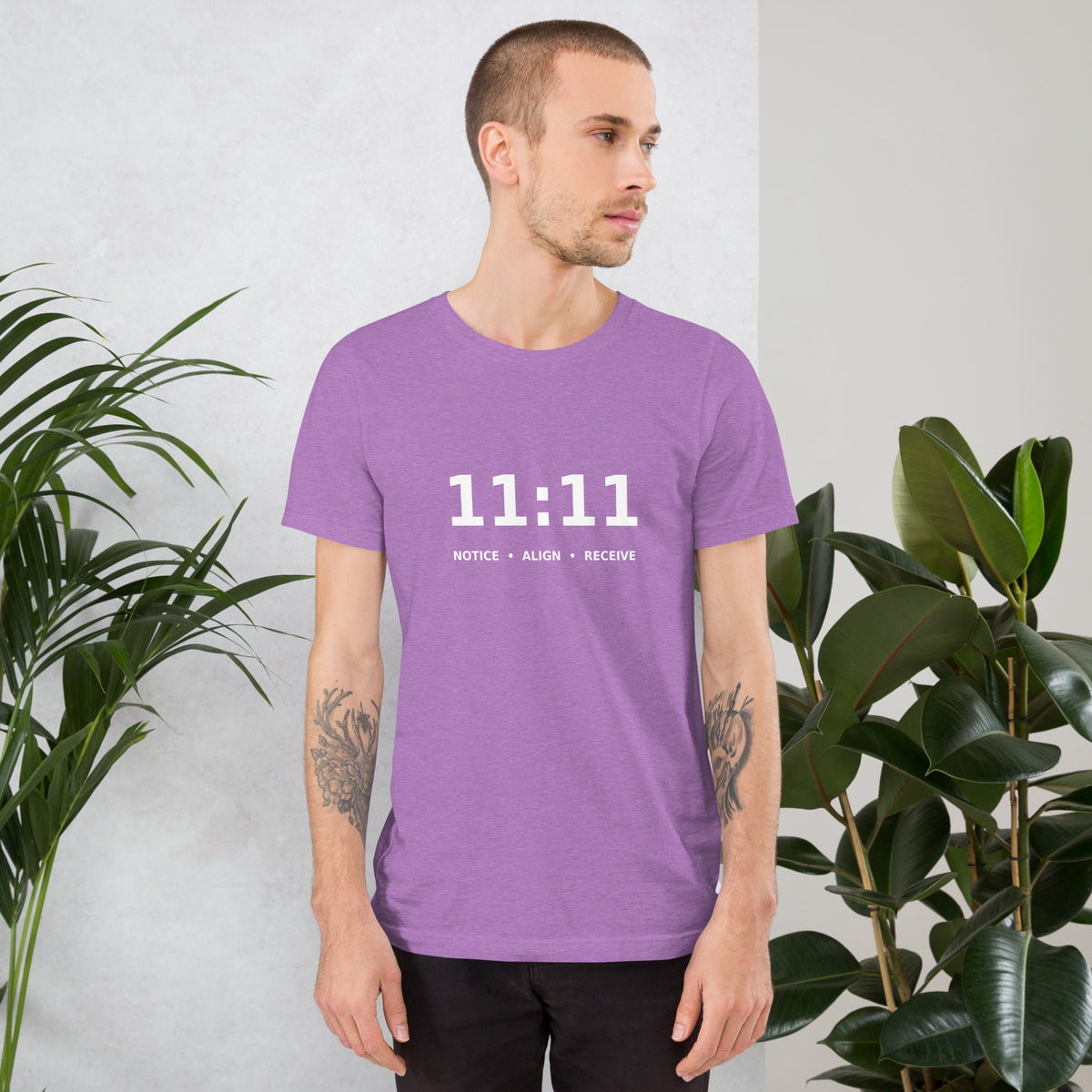11:11 angel number design, the number set in plain white type above Notice, Align, Receive, on a heather team purple unisex t-shirt, front view