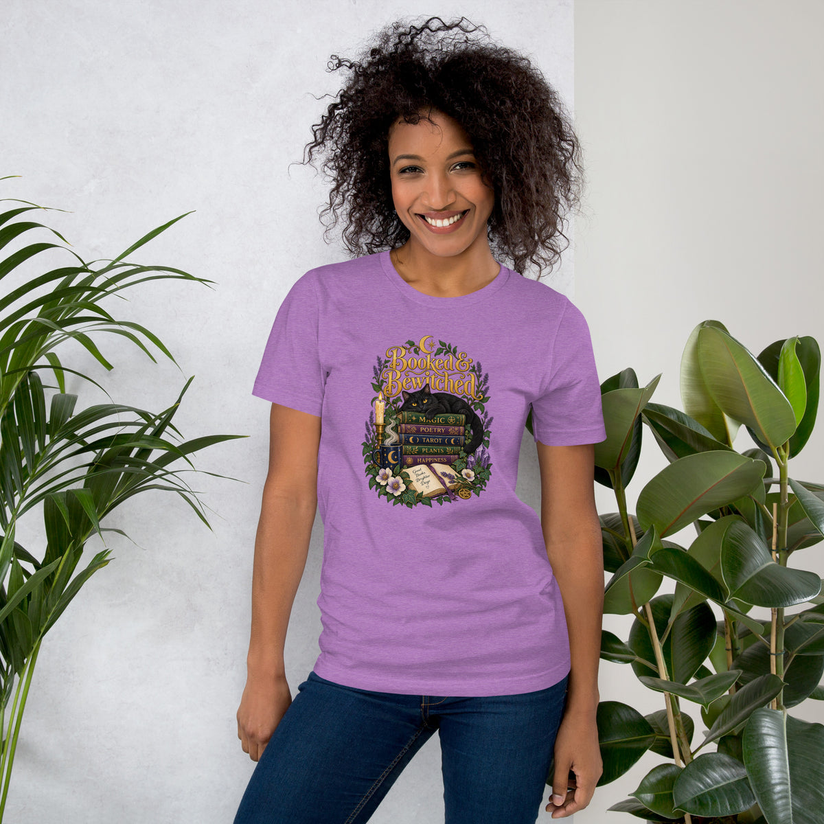 Booked and Bewitched dark academia design, a black cat asleep on a stack of spellbooks, on a heather team purple unisex t-shirt, front view