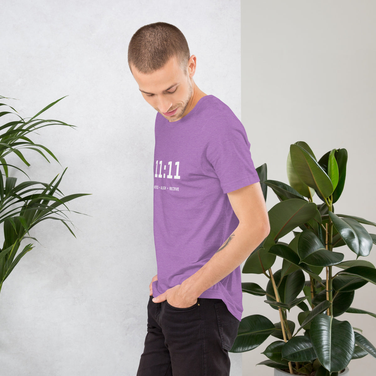 11:11 angel number design, the number set in plain white type above Notice, Align, Receive, on a heather team purple unisex t-shirt, left side view