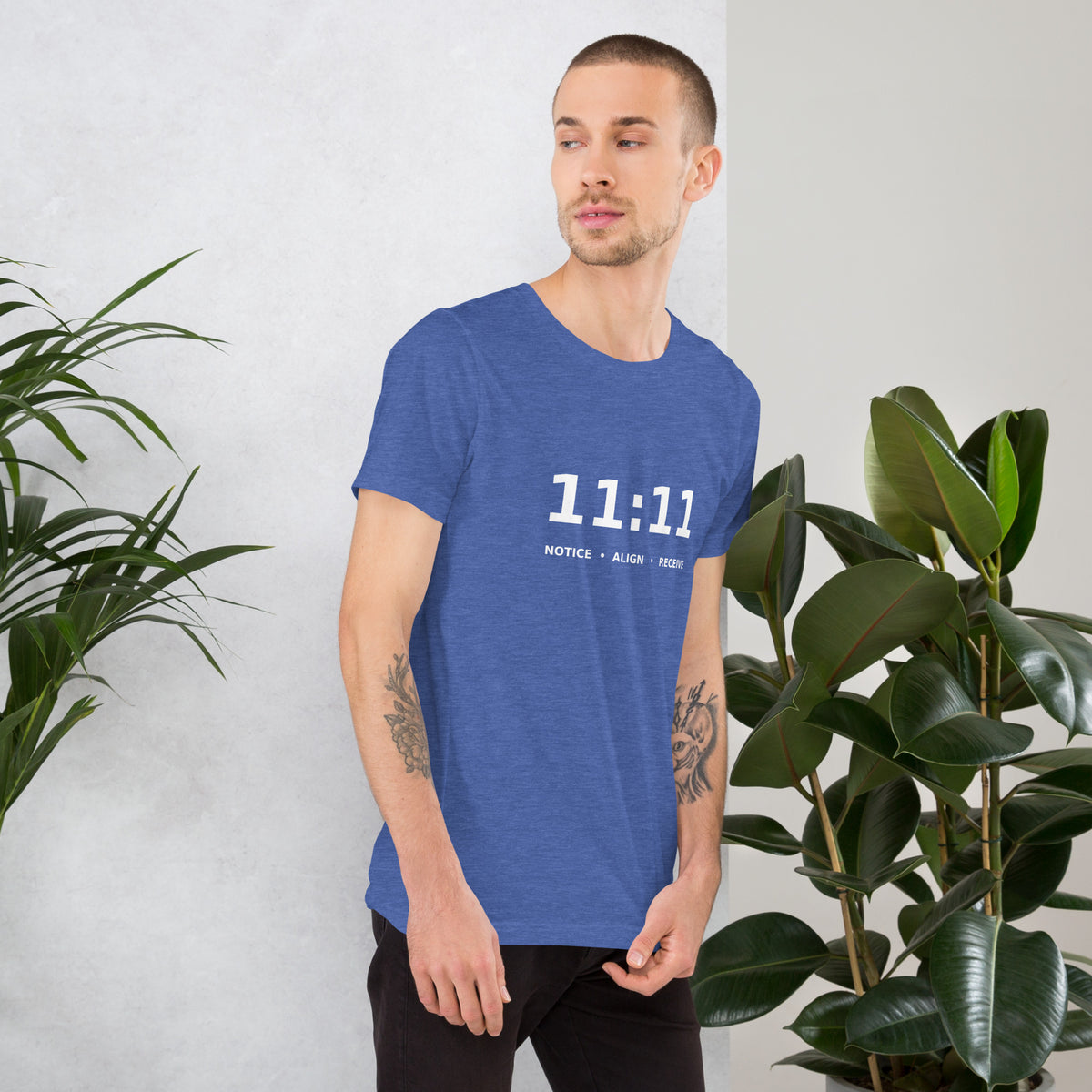 11:11 angel number design, the number set in plain white type above Notice, Align, Receive, on a heather true royal unisex t-shirt, right side view