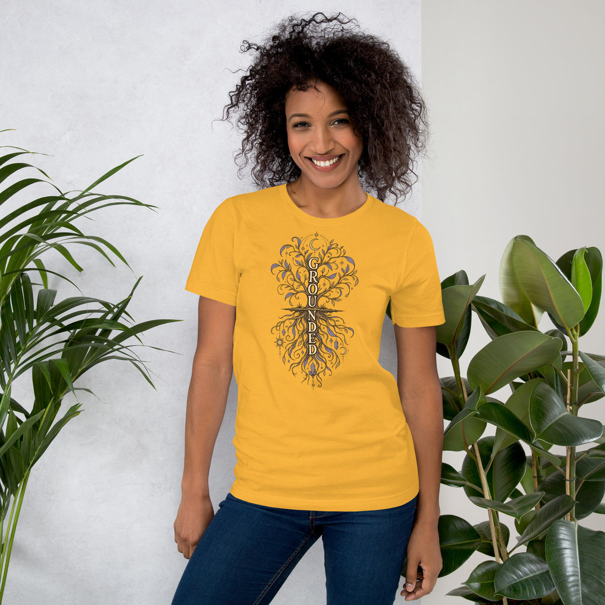 Own Your Grounded Energy design, an ornate tree with gold leaves and crystals in its roots, on a heather yellow gold unisex t-shirt, front view