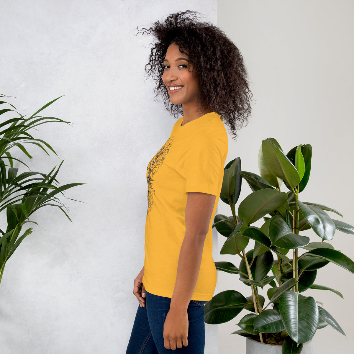 Own Your Grounded Energy design, an ornate tree with gold leaves and crystals in its roots, on a heather yellow gold unisex t-shirt, left side view