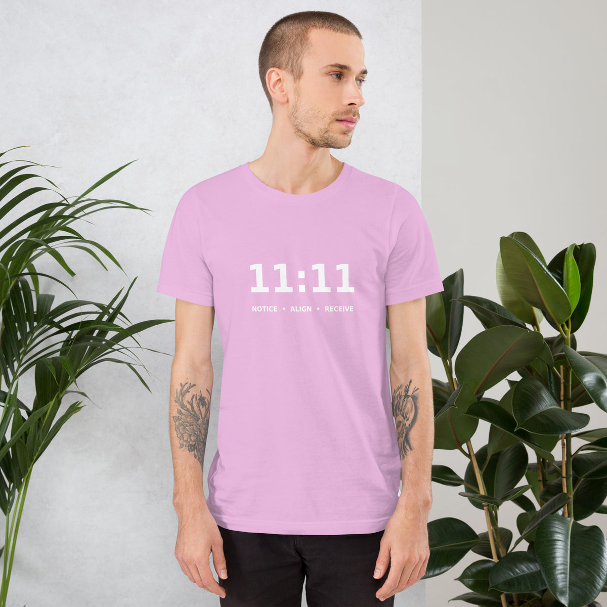 11:11 angel number design, the number set in plain white type above Notice, Align, Receive, on a lilac unisex t-shirt, front view