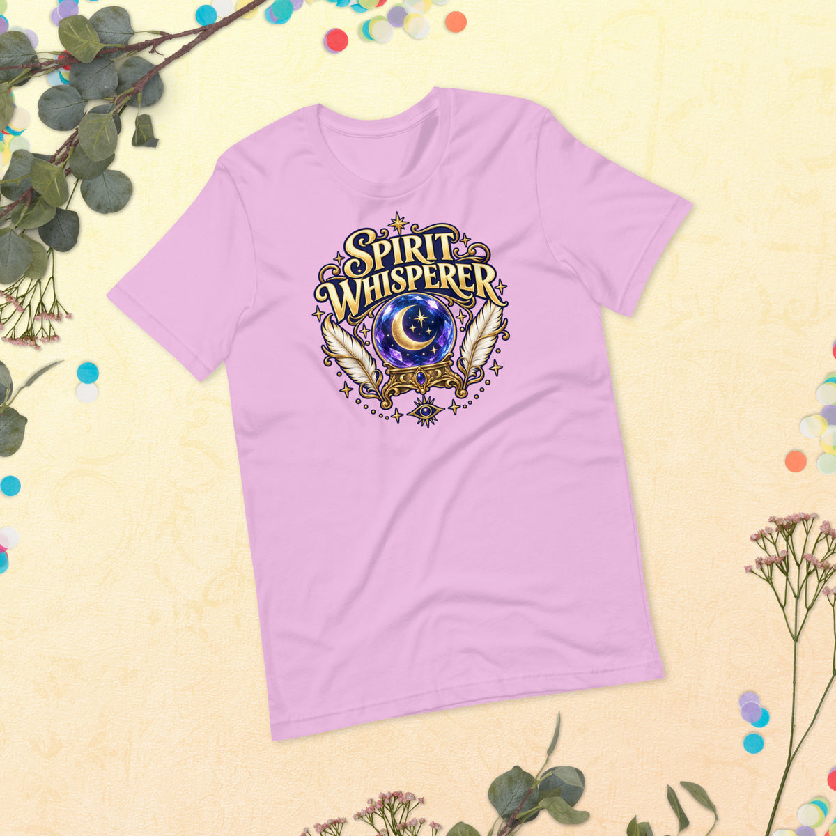 Spirit Whisperer unisex t-shirt in lilac, front, laid flat. A crystal ball and feathers in a gold roundel.