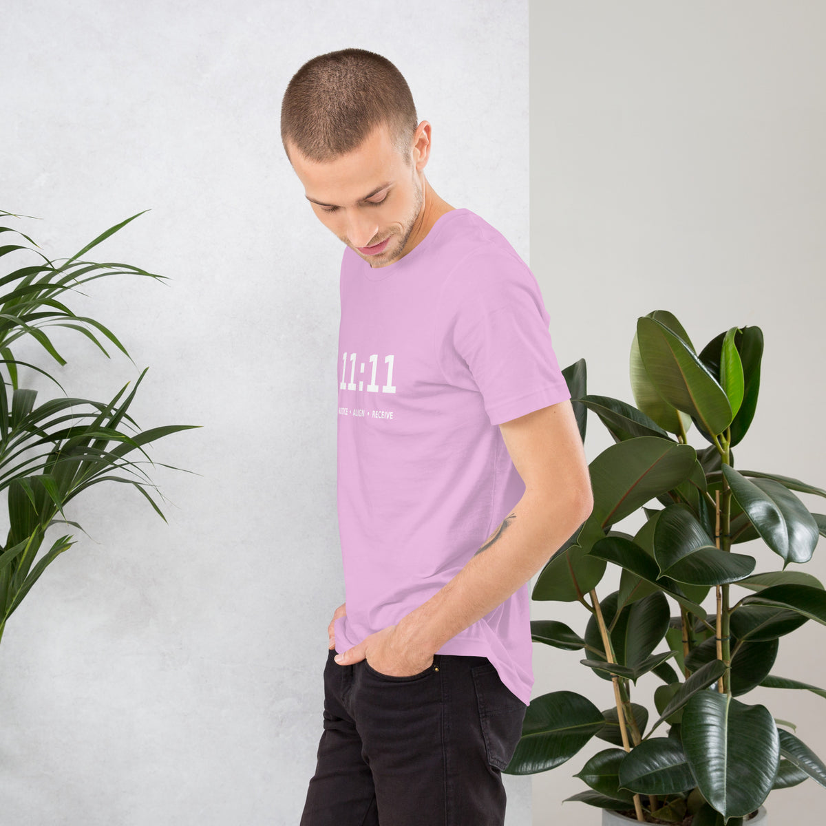 11:11 angel number design, the number set in plain white type above Notice, Align, Receive, on a lilac unisex t-shirt, left side view