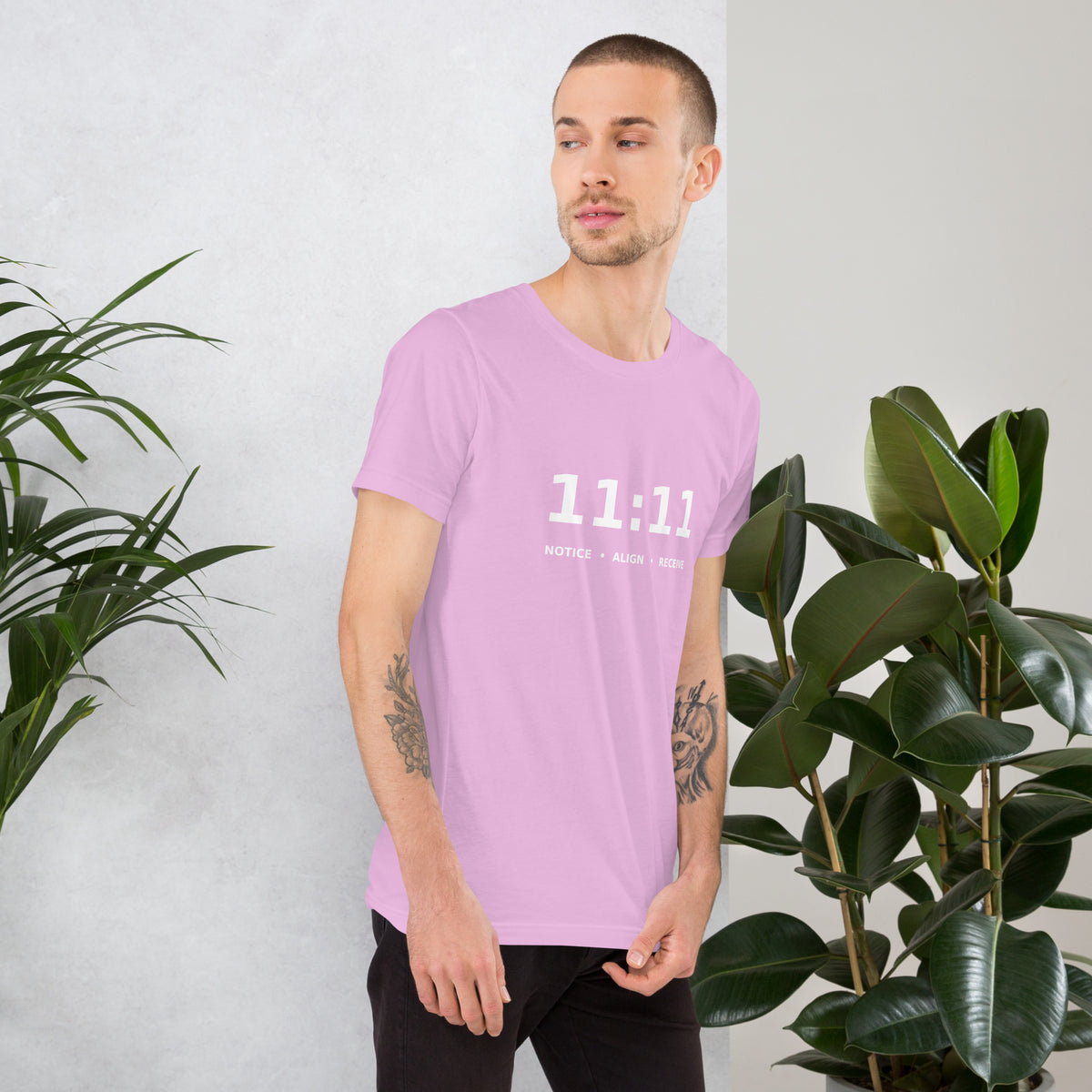11:11 angel number design, the number set in plain white type above Notice, Align, Receive, on a lilac unisex t-shirt, right side view