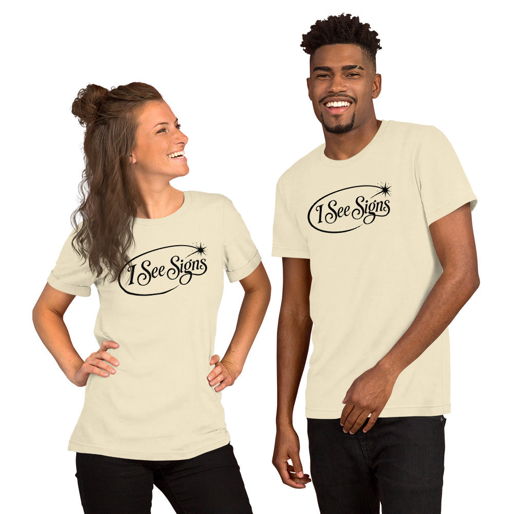 I See Signs design, the words set in black script inside a thin oval with a four-pointed star, on a natural unisex t-shirt, front view