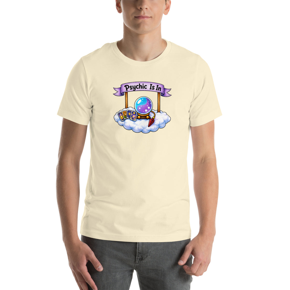 Psychic Is In design, playful floating clouds beneath a banner that reads Psychic Is Open for Business, on a natural unisex t-shirt, front view