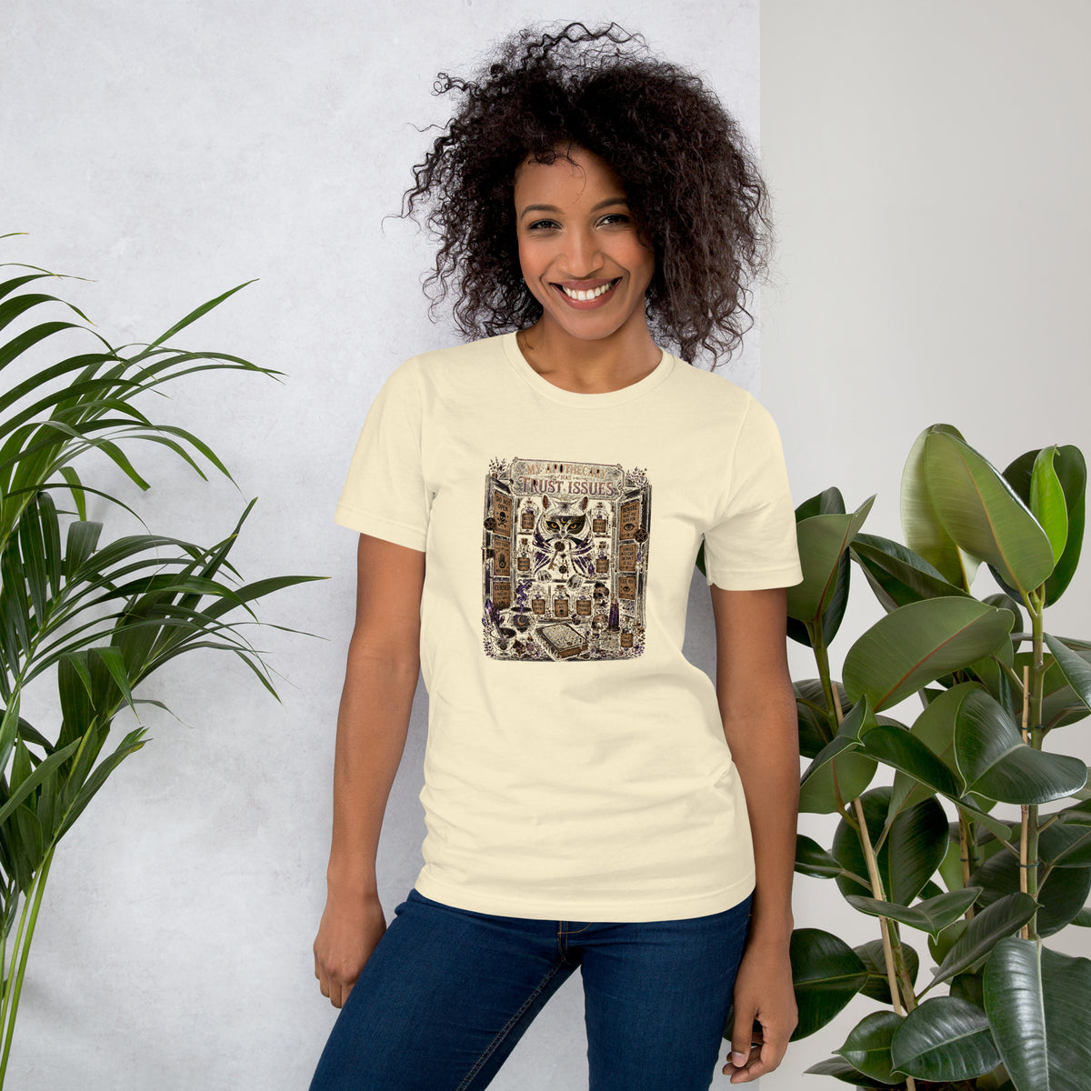 My Apothecary Has Trust Issues, a witchy black cat and a cabinet of potion bottles, on a natural unisex t-shirt, front view