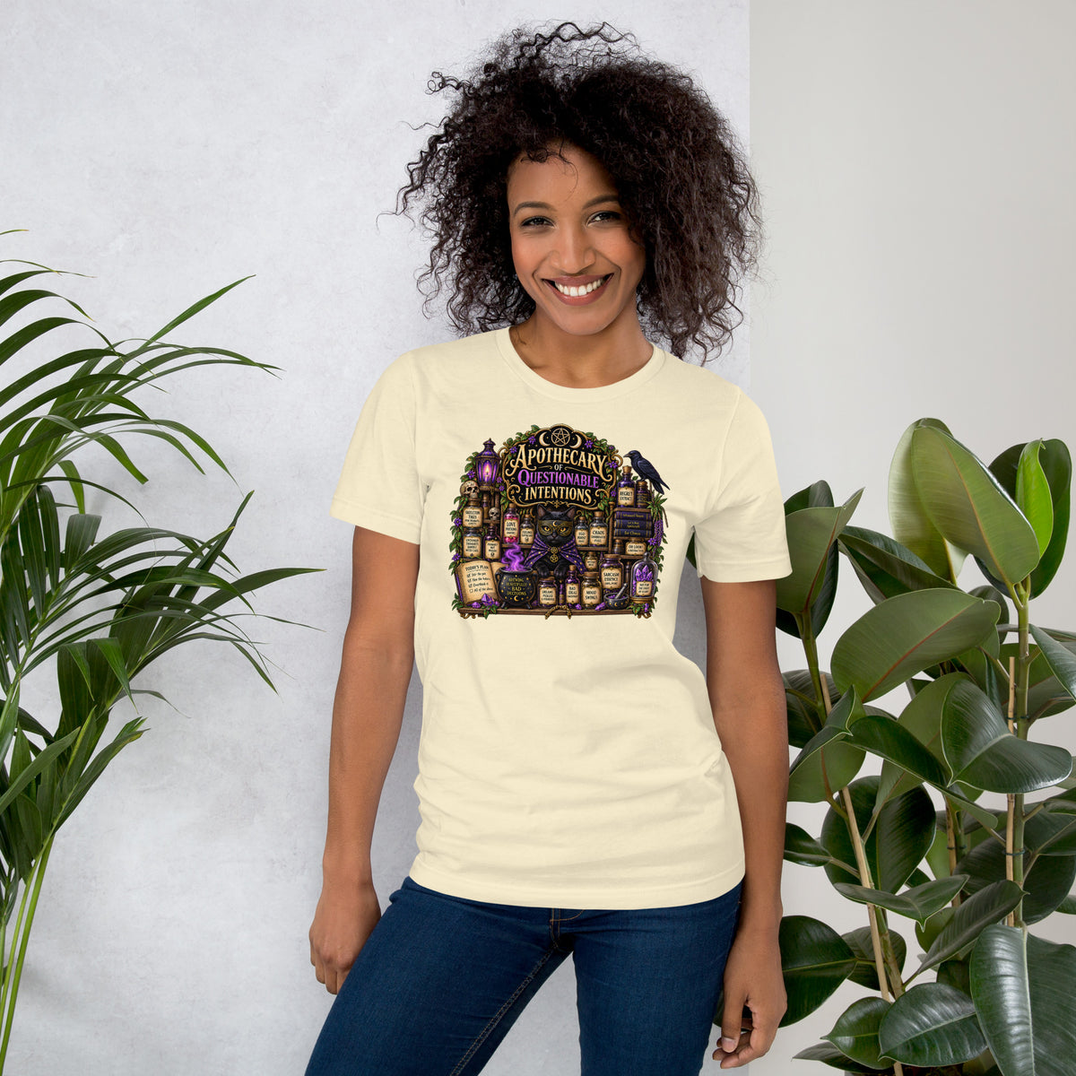 Apothecary of Questionable Intentions, a witchy black cat and two dozen potion bottles, on a natural unisex t-shirt, front view