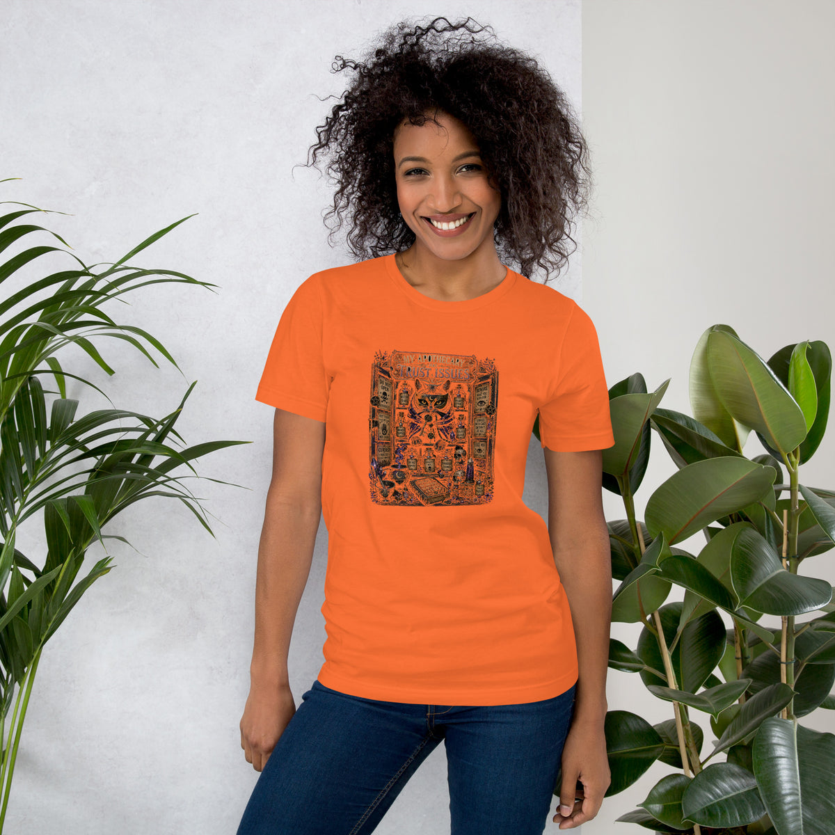 My Apothecary Has Trust Issues, a witchy black cat and a cabinet of potion bottles, on an orange unisex t-shirt, front view