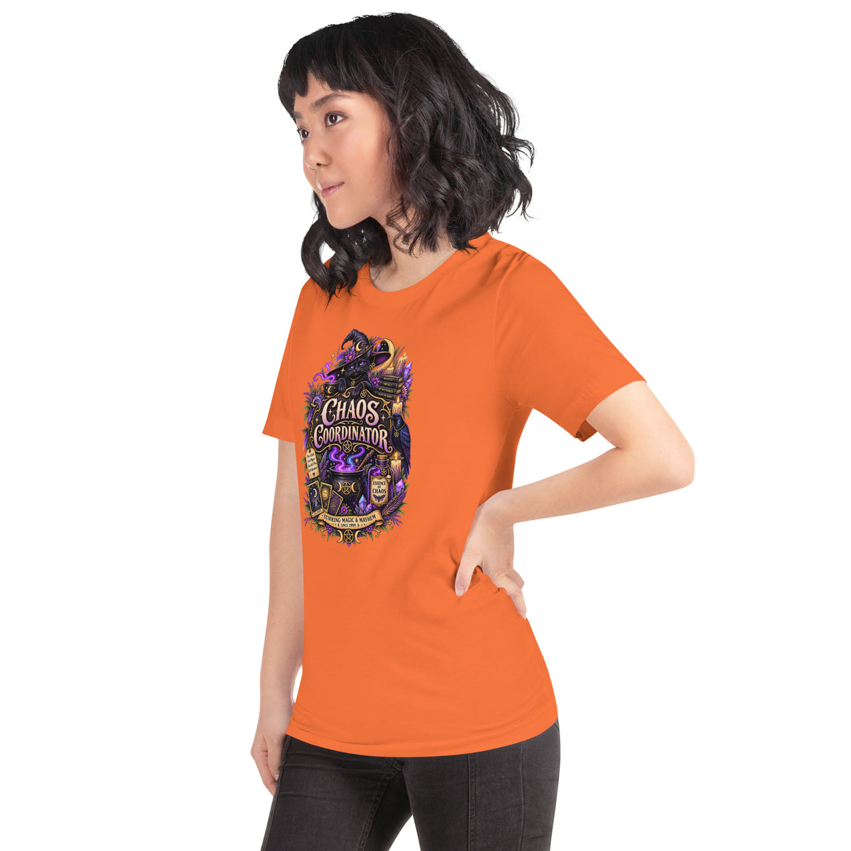 Chaos Coordinator whimsigoth design, a witchy black cat in a pointed hat, on an orange unisex t-shirt, left front view
