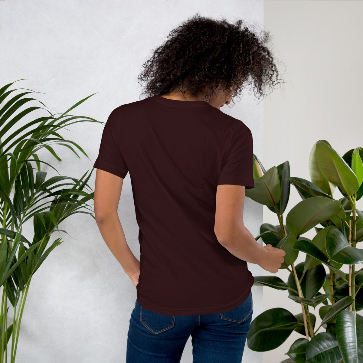 My Apothecary Has Trust Issues, a witchy black cat and a cabinet of potion bottles, on an oxblood black unisex t-shirt, back view