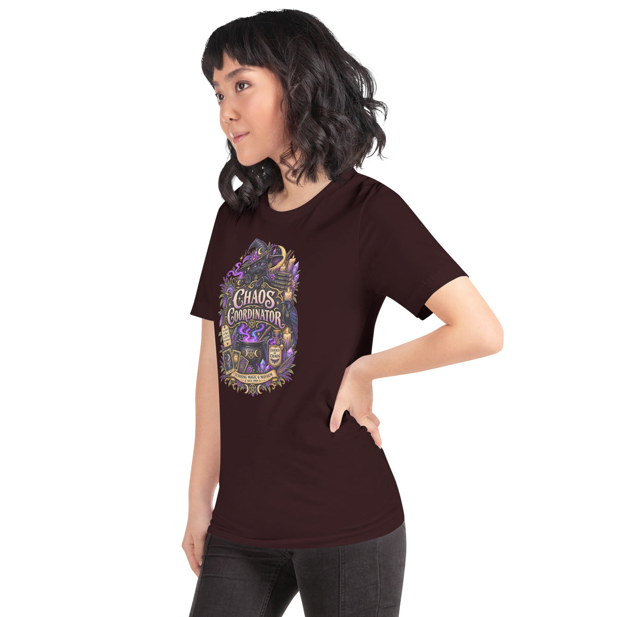 Chaos Coordinator whimsigoth design, a witchy black cat in a pointed hat, on an oxblood black unisex t-shirt, left front view