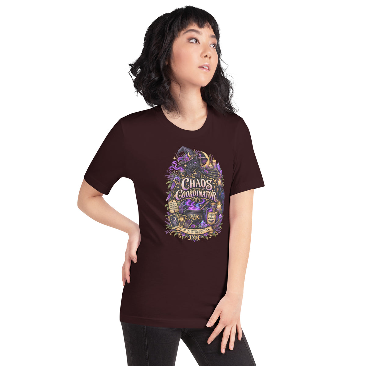 Chaos Coordinator whimsigoth design, a witchy black cat in a pointed hat, on an oxblood black unisex t-shirt, right front view