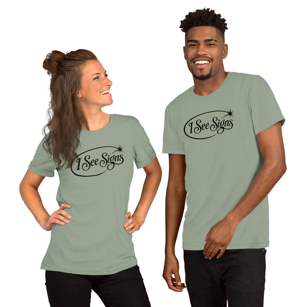 I See Signs design, the words set in black script inside a thin oval with a four-pointed star, on a sage unisex t-shirt, front view