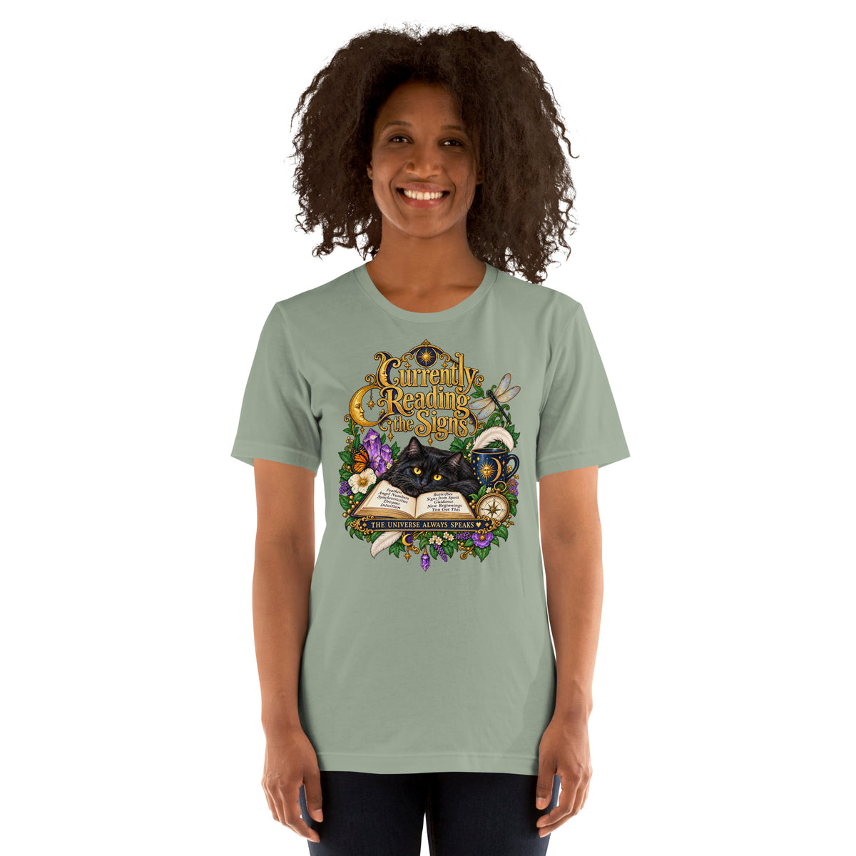 Currently Reading The Signs dark academia design, two black cats asleep over an open book beneath a crescent moon, on a sage unisex t-shirt, front view