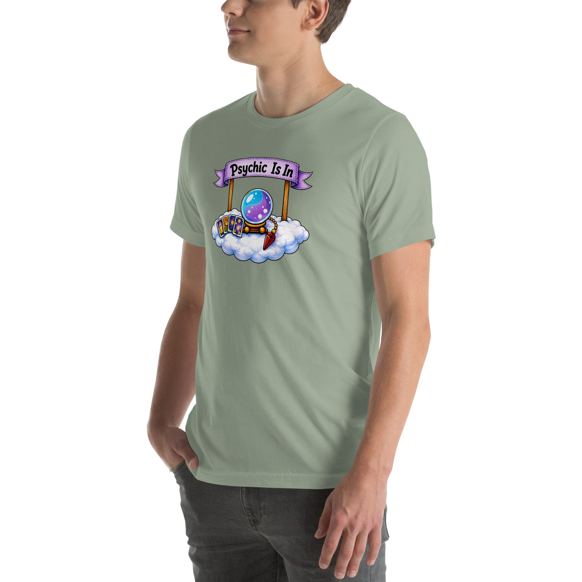 Psychic Is In design, playful floating clouds beneath a banner that reads Psychic Is Open for Business, on a sage unisex t-shirt, angled left front view