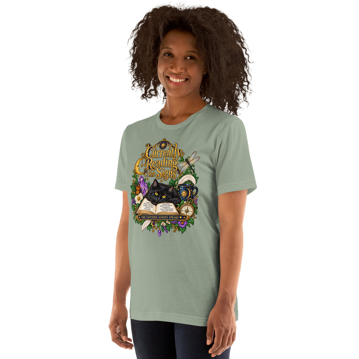 Currently Reading The Signs dark academia design, two black cats asleep over an open book beneath a crescent moon, on a sage unisex t-shirt, left front view