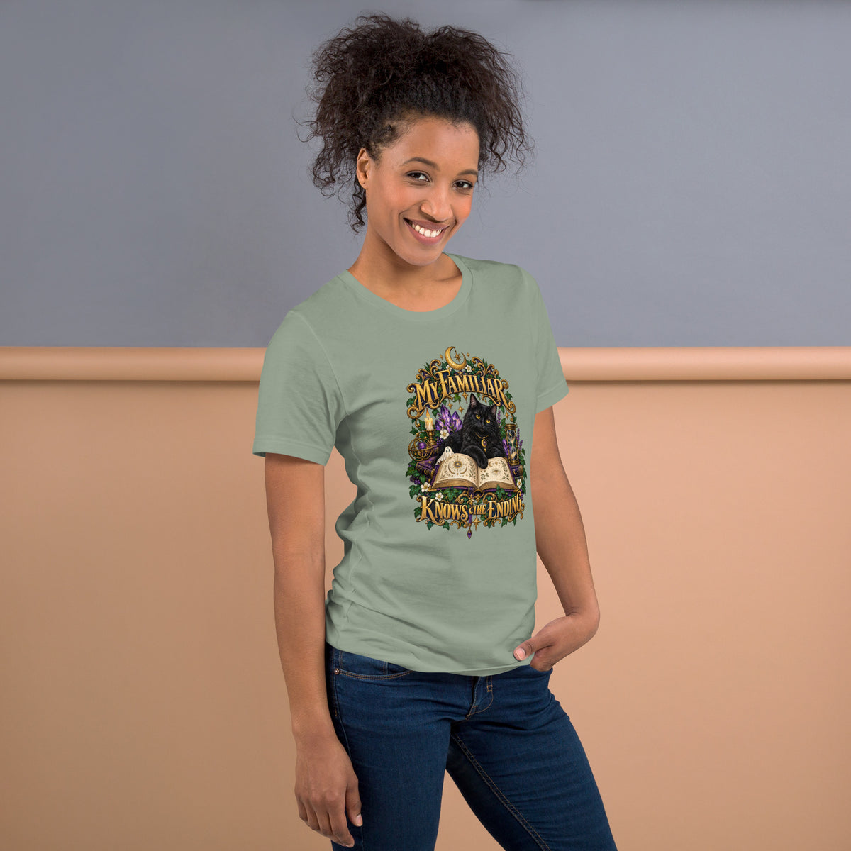 Black cat familiar on a grimoire, dark academia design on a sage unisex t-shirt, right side