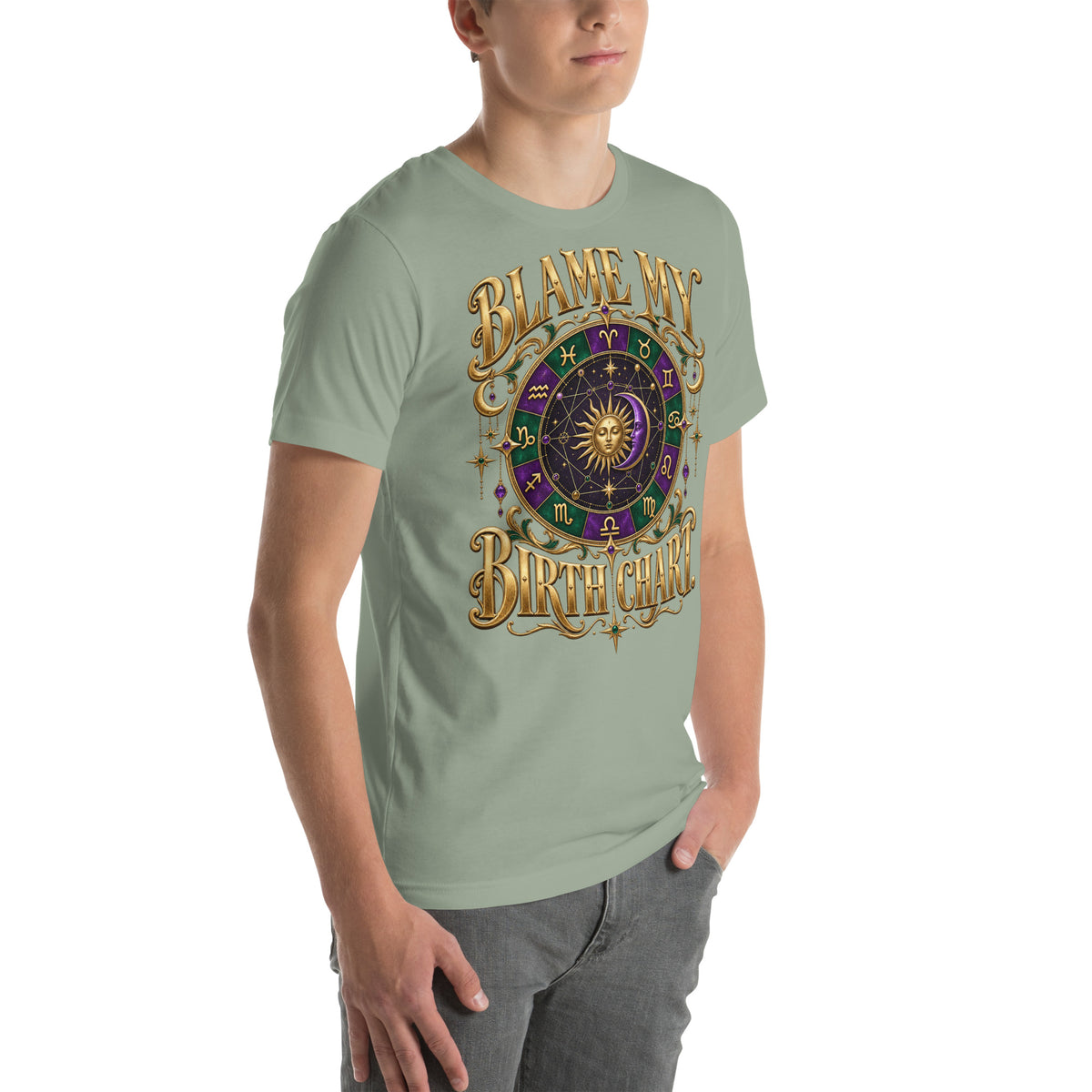 Blame My Birth Chart astrology design, a purple and green zodiac wheel with a gold sun face and crescent moon at its center, hung with gold ornaments, on a sage unisex t-shirt, angled right front view