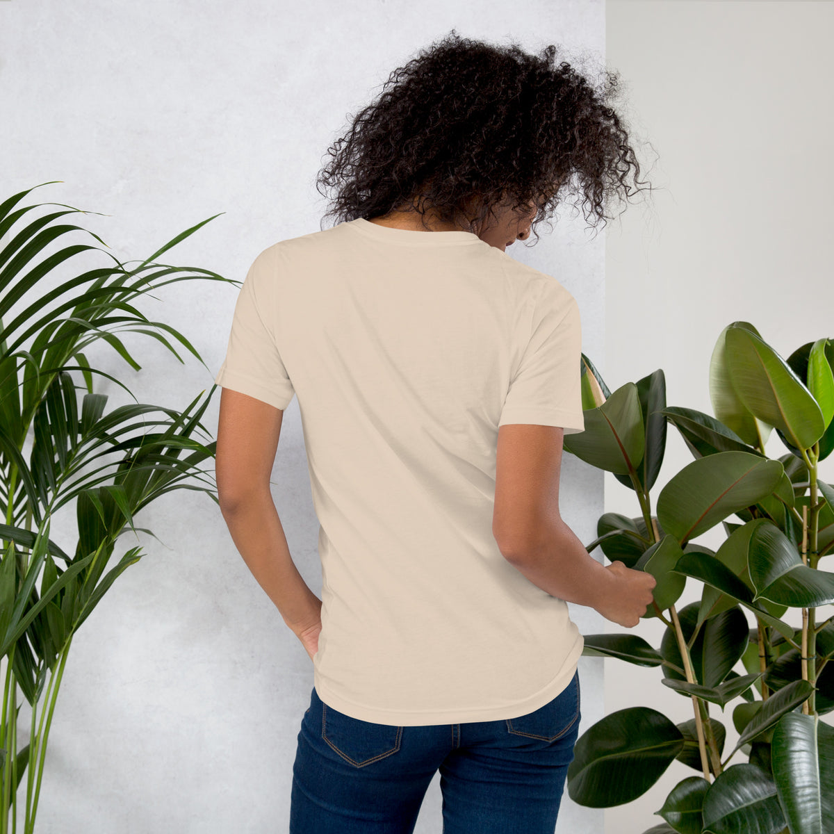 My Apothecary Has Trust Issues, a witchy black cat and a cabinet of potion bottles, on a soft cream unisex t-shirt, back view