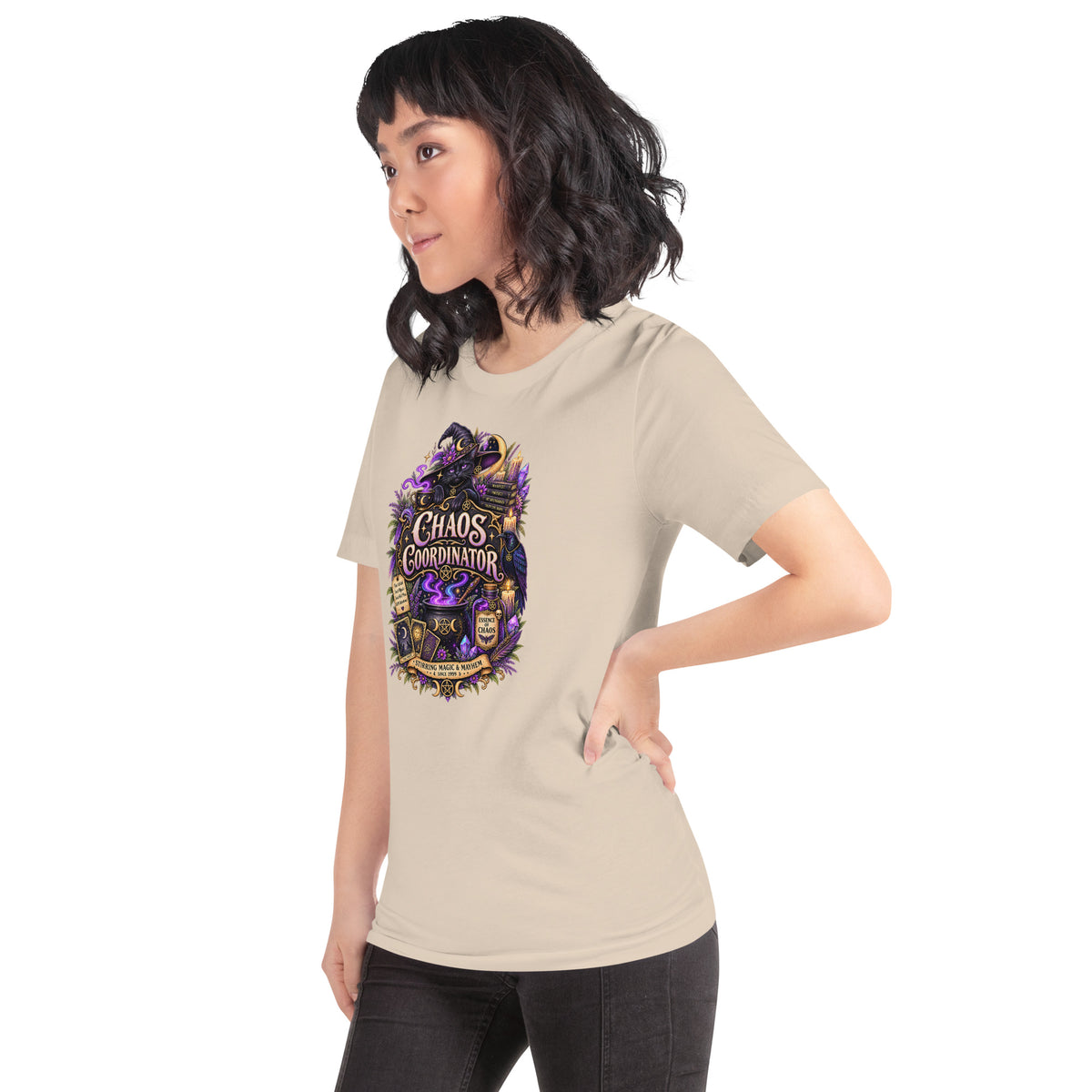 Chaos Coordinator whimsigoth design, a witchy black cat in a pointed hat, on a soft cream unisex t-shirt, left front view