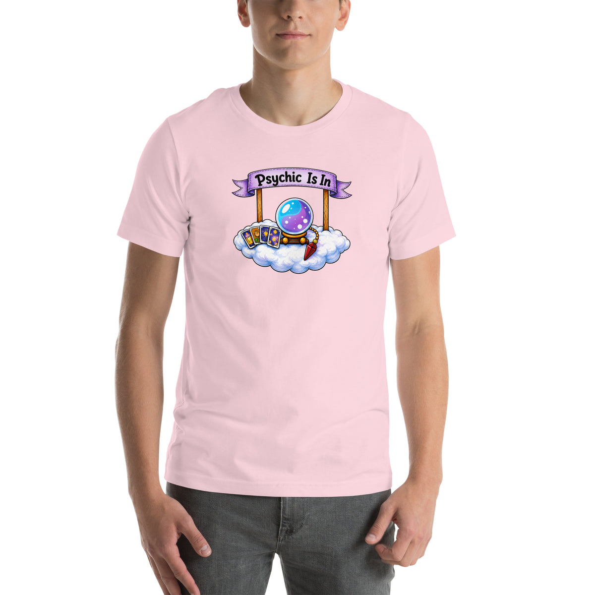 Psychic Is In design, playful floating clouds beneath a banner that reads Psychic Is Open for Business, on a soft pink unisex t-shirt, front view