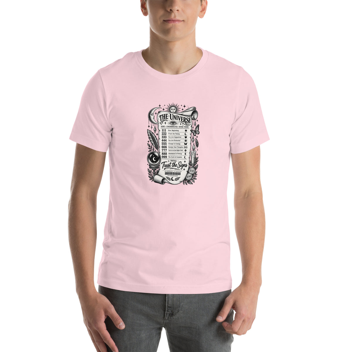 Trust the Signs design, a receipt from the Universe listing the angel numbers and their meanings, with a crystal ball and a candle, on a soft pink unisex t-shirt, front view