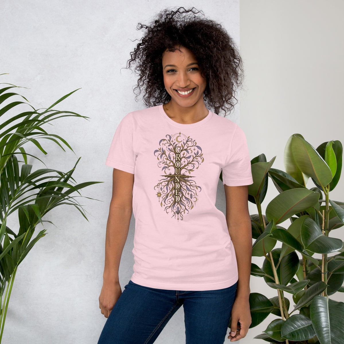 Own Your Grounded Energy design, an ornate tree with gold leaves and crystals in its roots, on a soft pink unisex t-shirt, front view