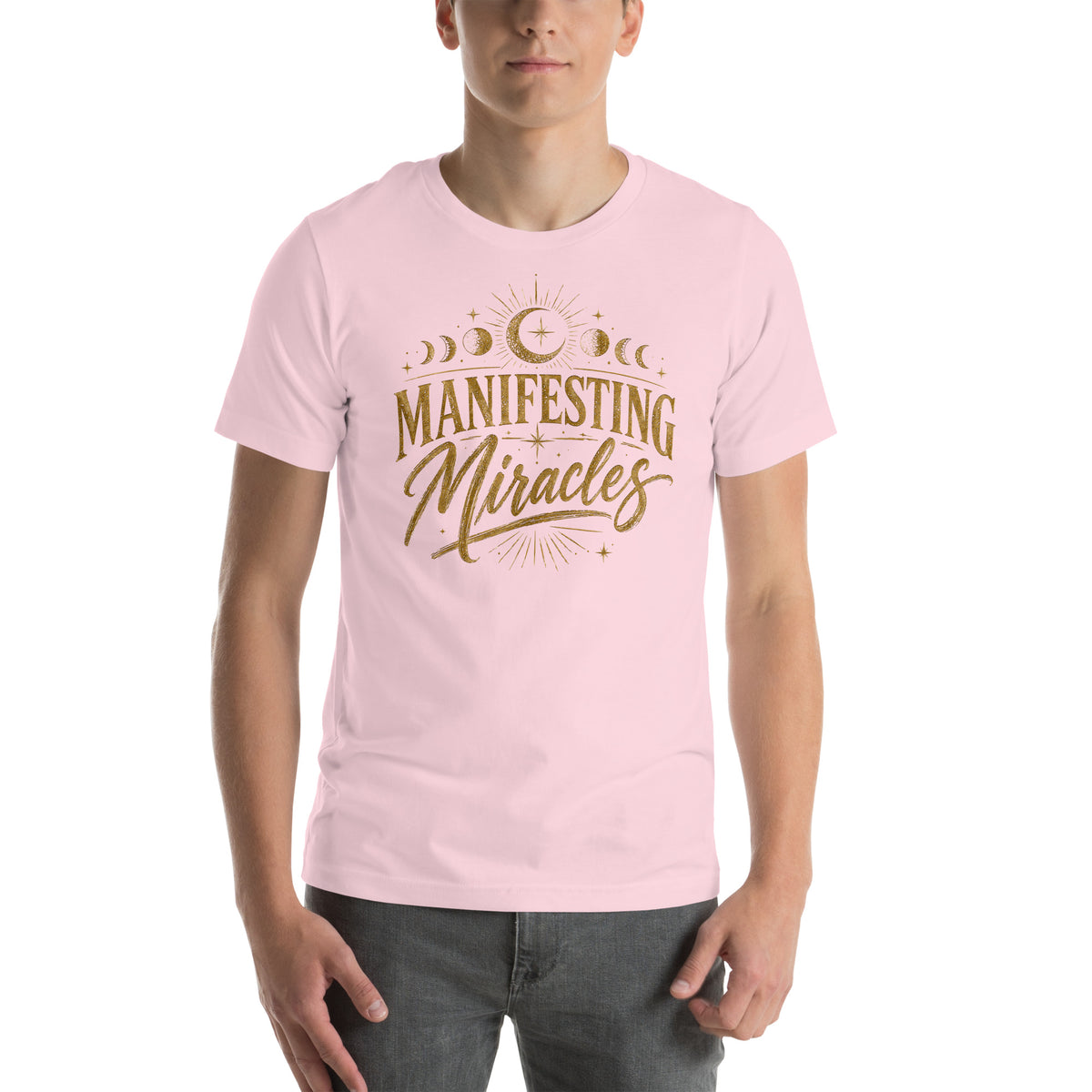 Manifesting Miracles design with moon phases in antique gold, on a soft pink unisex t-shirt, front view