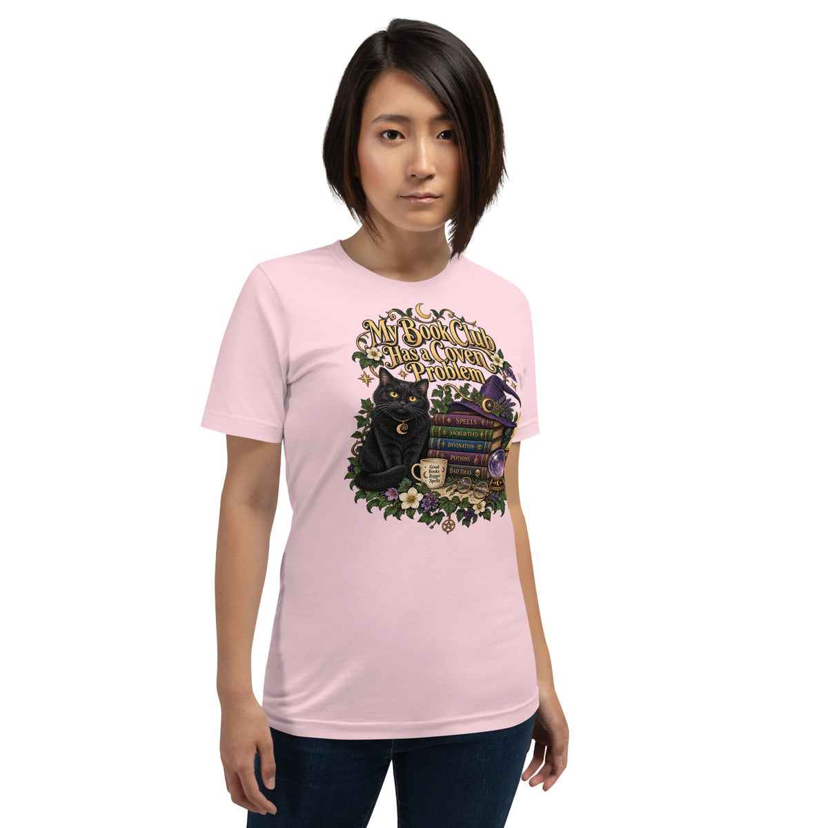 My Book Club Has A Coven Problem dark academia design, a witchy black cat and a stack of spellbooks, on a soft pink unisex t-shirt, front view