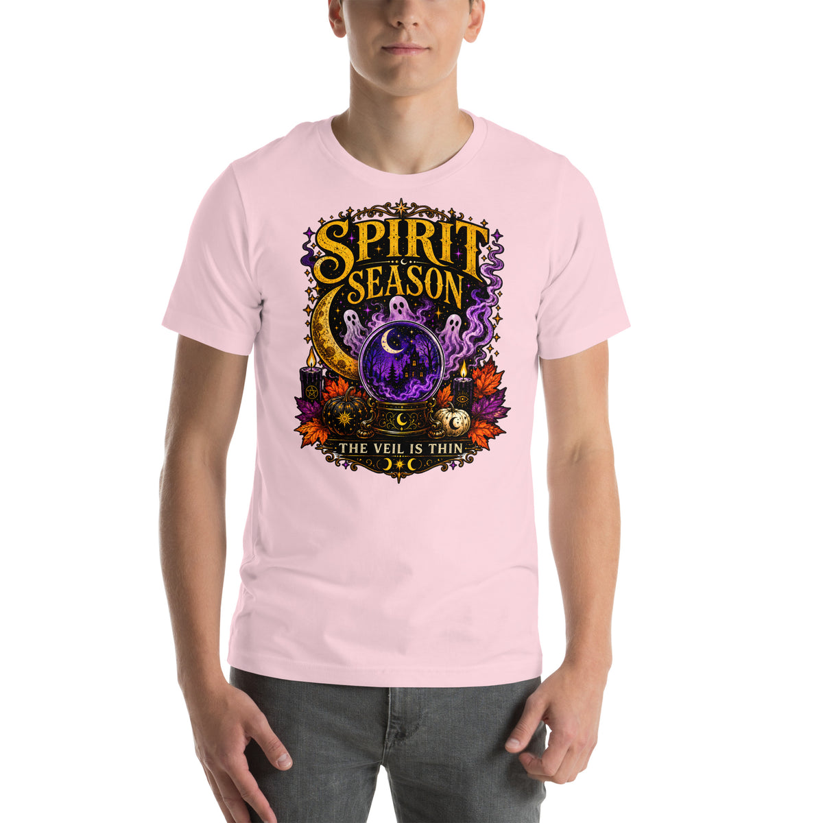 Spirit Season The Veil Is Thin design, three ghosts around a crystal ball, on a soft pink unisex t-shirt, front view