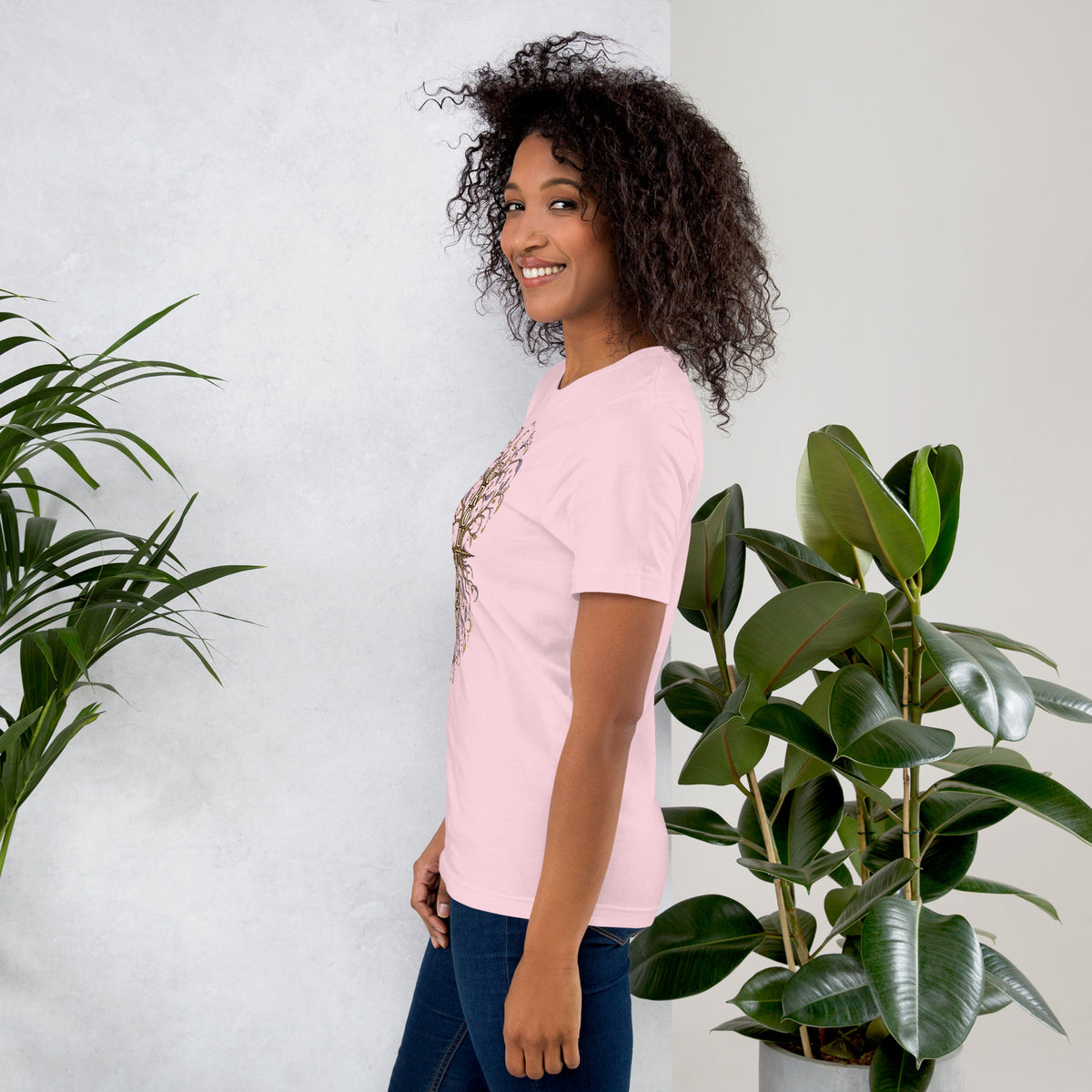 Own Your Grounded Energy design, an ornate tree with gold leaves and crystals in its roots, on a soft pink unisex t-shirt, left side view