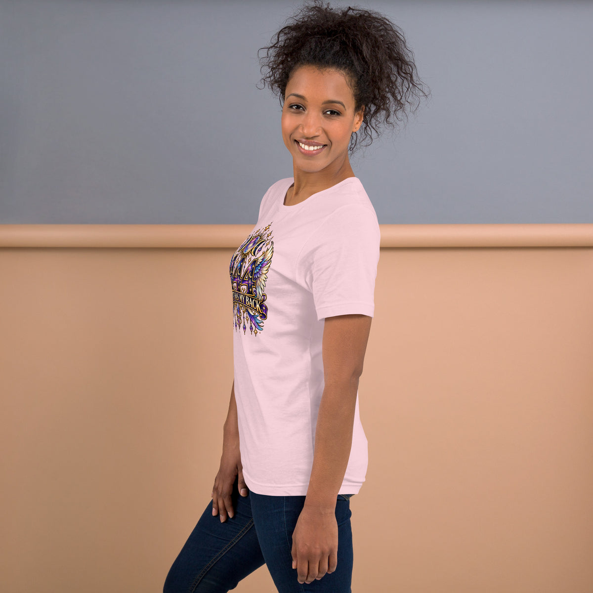 444 Spirit Has My Back angel number design, angel wings flanking the number beneath a galaxy orb and crescent moons, on a soft pink unisex t-shirt, left side view