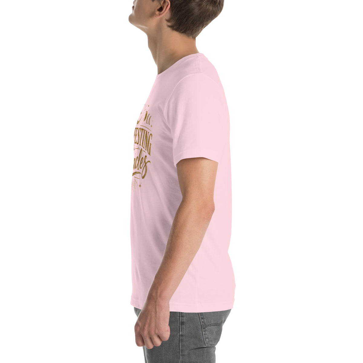 Manifesting Miracles design with moon phases in antique gold, on a soft pink unisex t-shirt, left side view