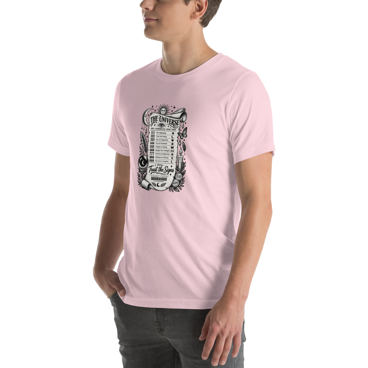 Trust the Signs design, a receipt from the Universe listing the angel numbers and their meanings, with a crystal ball and a candle, on a soft pink unisex t-shirt, angled left front view
