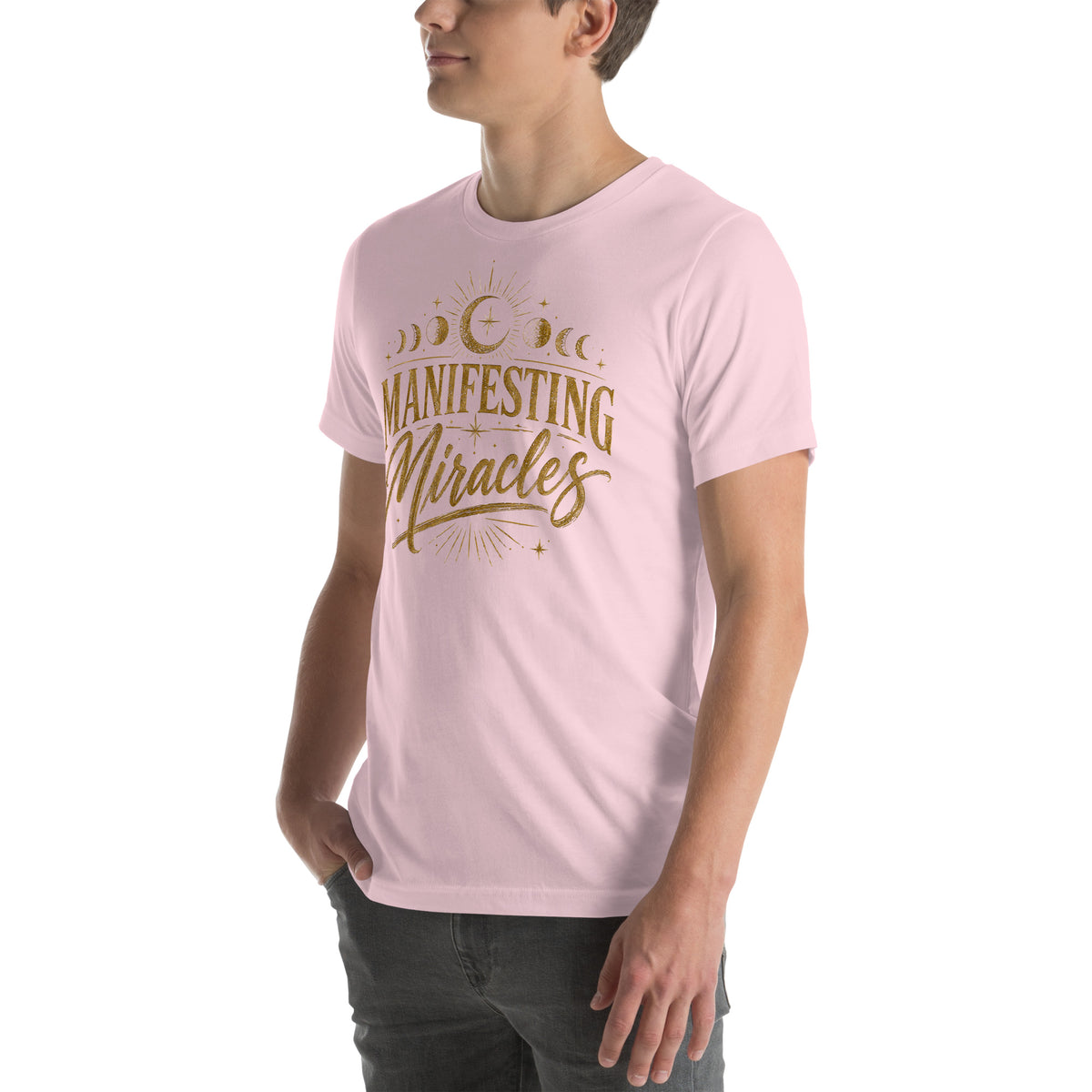 Manifesting Miracles design with moon phases in antique gold, on a soft pink unisex t-shirt, angled left front view