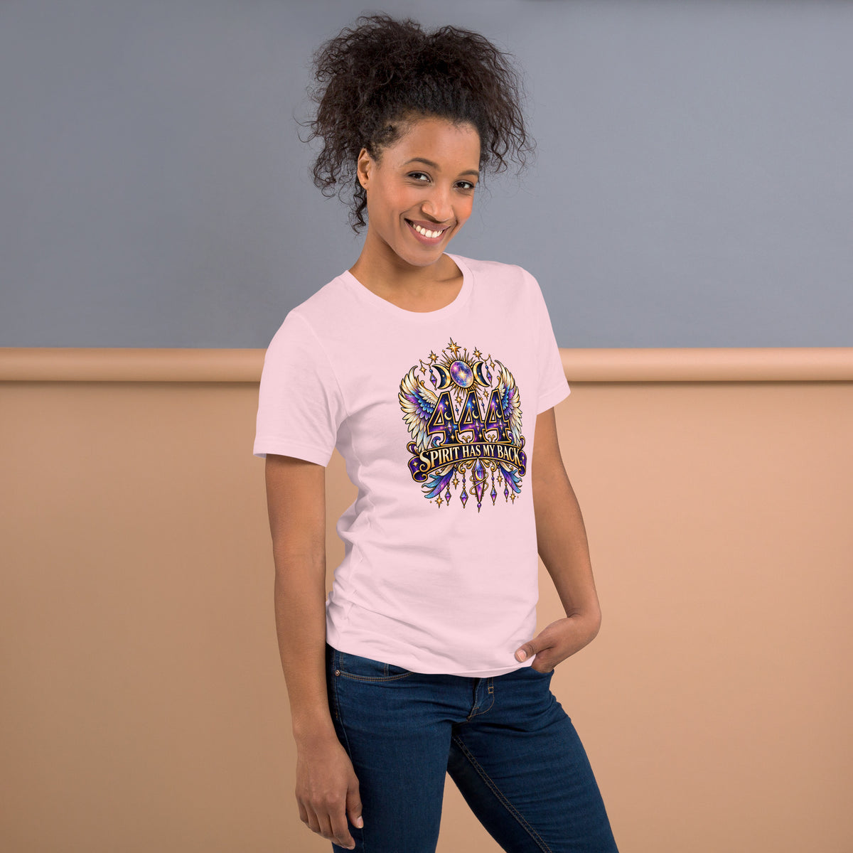 444 Spirit Has My Back angel number design, angel wings flanking the number beneath a galaxy orb and crescent moons, on a soft pink unisex t-shirt, right side view