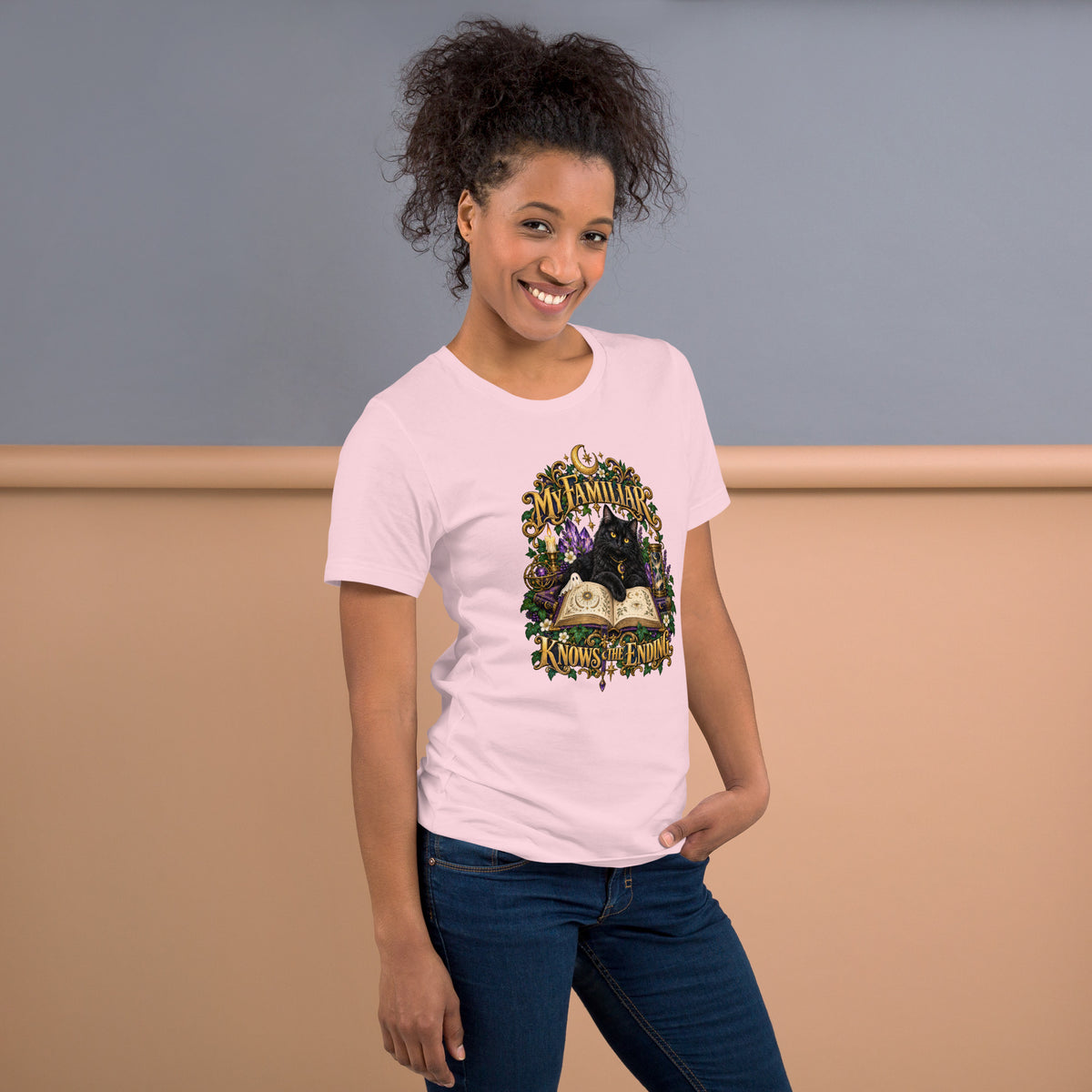 Black cat familiar on a grimoire, witchy celestial design on a soft pink unisex t-shirt, right side