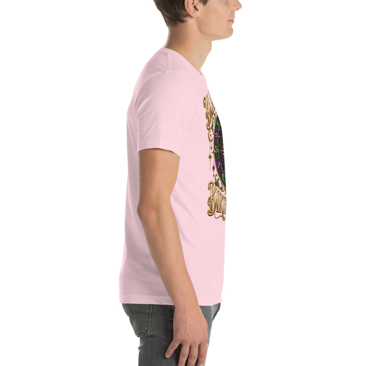 Blame My Birth Chart astrology design, a purple and green zodiac wheel with a gold sun face and crescent moon at its center, hung with gold ornaments, on a soft pink unisex t-shirt, right side view