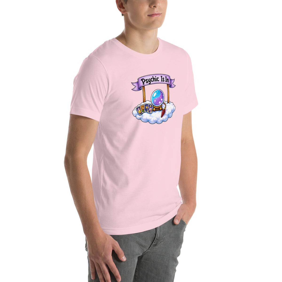 Psychic Is In design, playful floating clouds beneath a banner that reads Psychic Is Open for Business, on a soft pink unisex t-shirt, angled right front view