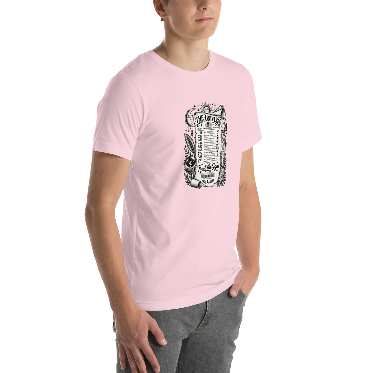 Trust the Signs design, a receipt from the Universe listing the angel numbers and their meanings, with a crystal ball and a candle, on a soft pink unisex t-shirt, angled right front view