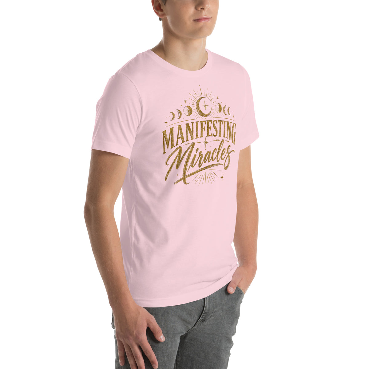 Manifesting Miracles design with moon phases in antique gold, on a soft pink unisex t-shirt, angled right front view
