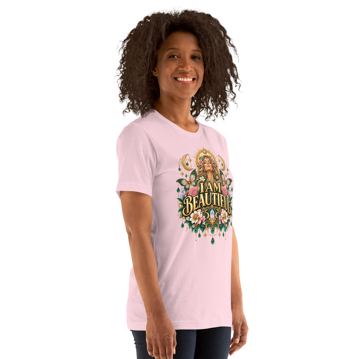 I Am Beautiful affirmation design with roses, butterflies and twin crescents in gold, on a soft pink unisex t-shirt, angled right front view