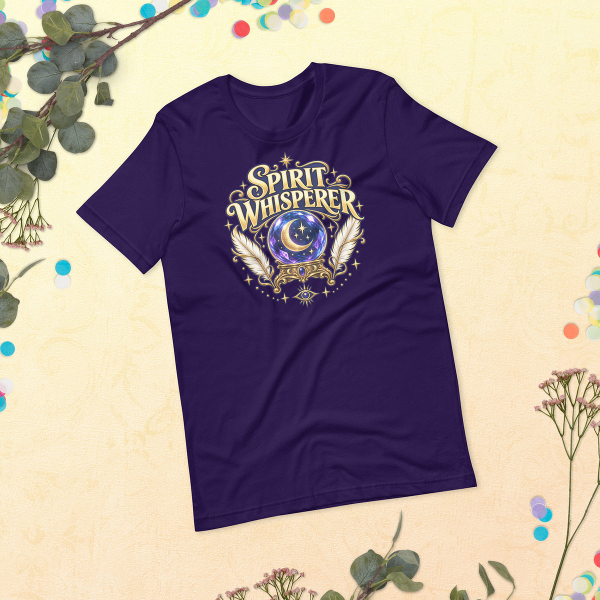 Spirit Whisperer unisex t-shirt in team purple, front, laid flat. A crystal ball and feathers in a gold roundel with an eye beneath.